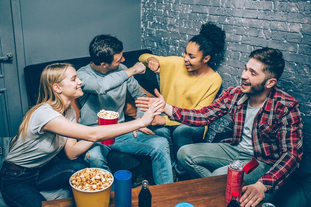 A group of friends playing a video game together online | Premium AI ... How to make friends while playing online games